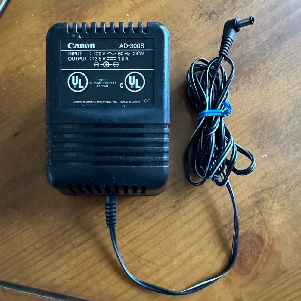 Genuine Canon AD-300S power supply  input: 120V ~ 60 Hz 24W output: 13.5V 1.0A